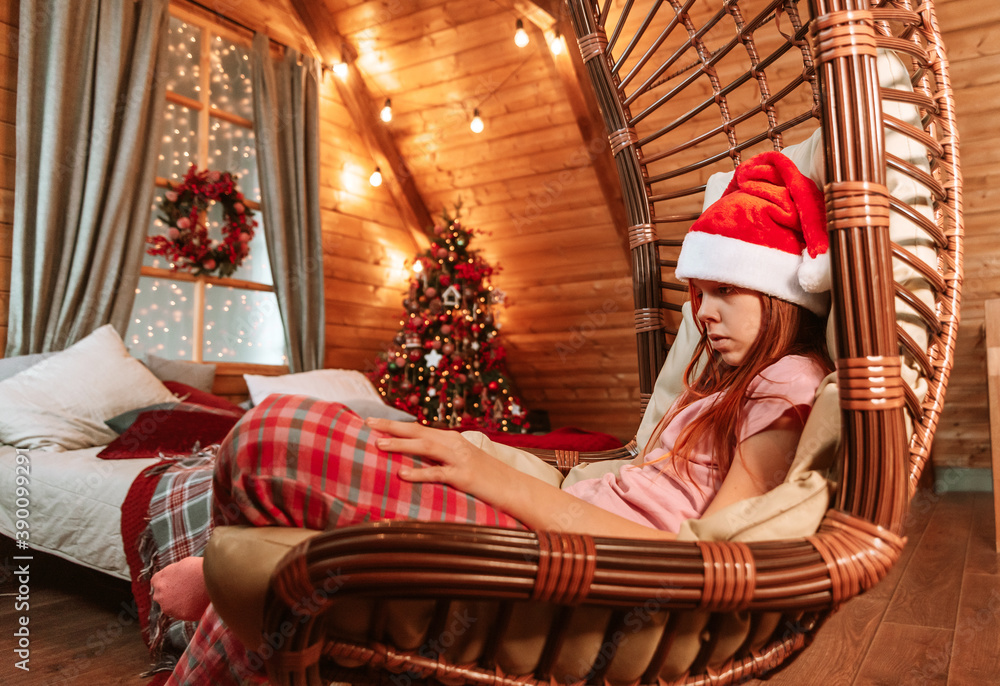 teen girl sit in a hammock in a Christmas interior