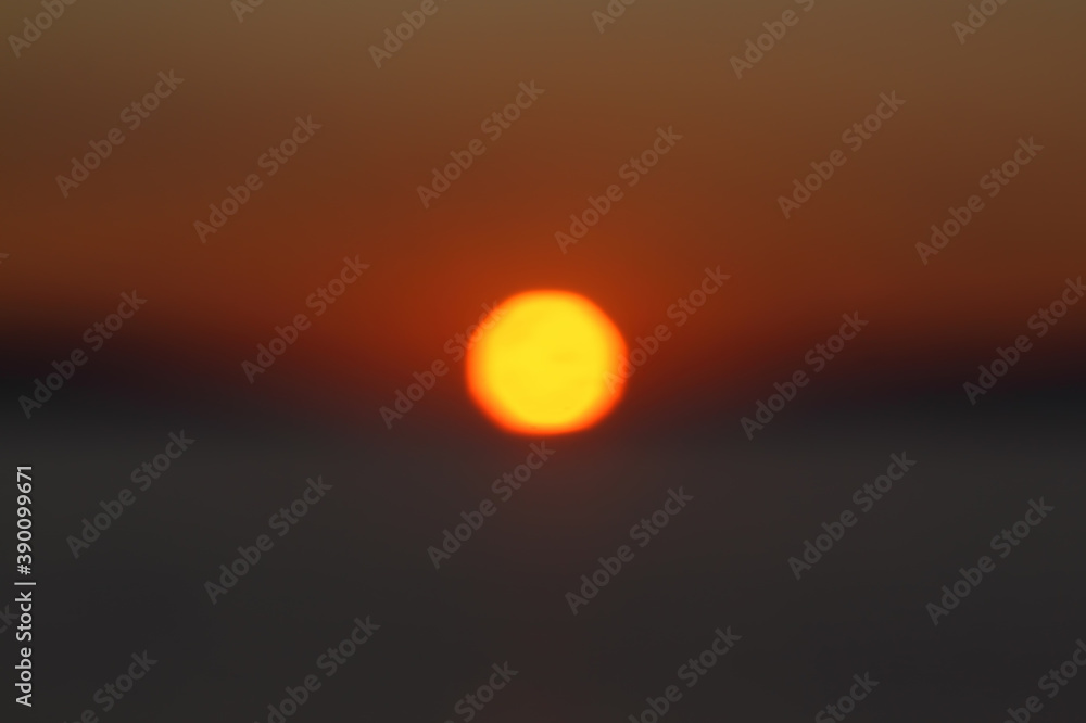 Unfocused blured multicolored background bokeh of sunset.