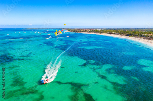 Tourists parasailing near Bavaro Beach, Punta Cana in Dominican Republic. Aerial view of tropical resort photo