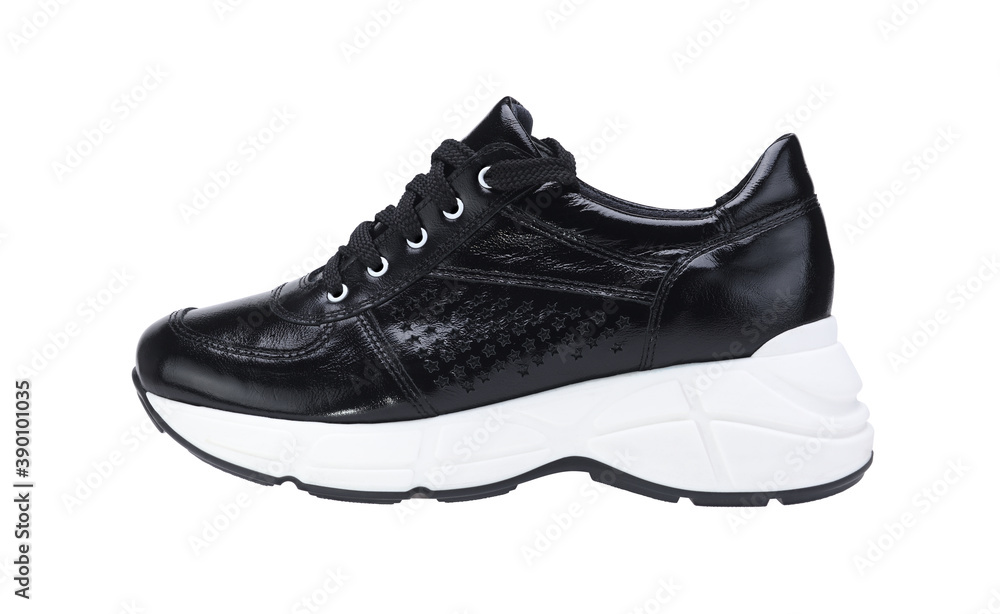 Women's stylish black sneakers on a white sole on a white background.