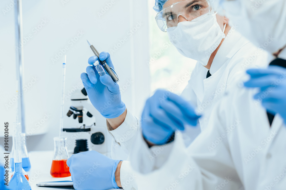 close up. group of scientists in protective clothing working in the laboratory. close up. group of scientists in protective clothing working in the laboratory.
