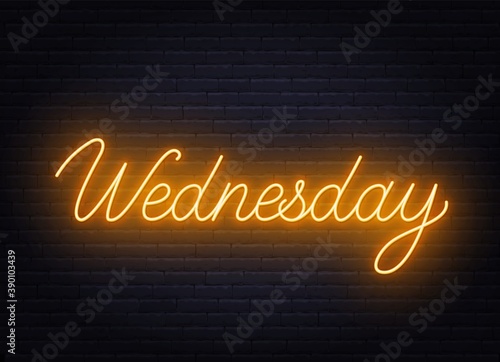 Wednesday neon sign on brick wall background .