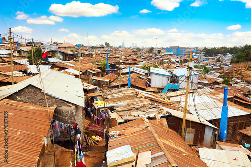 Kibera slum in Nairobi during sunny day with blue sky and clouds. Kibera is the biggest slum in Africa. Slums in Nairobi, Kenya. photo