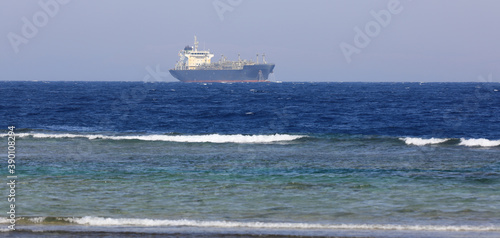 a cargo ship is sailing at sea