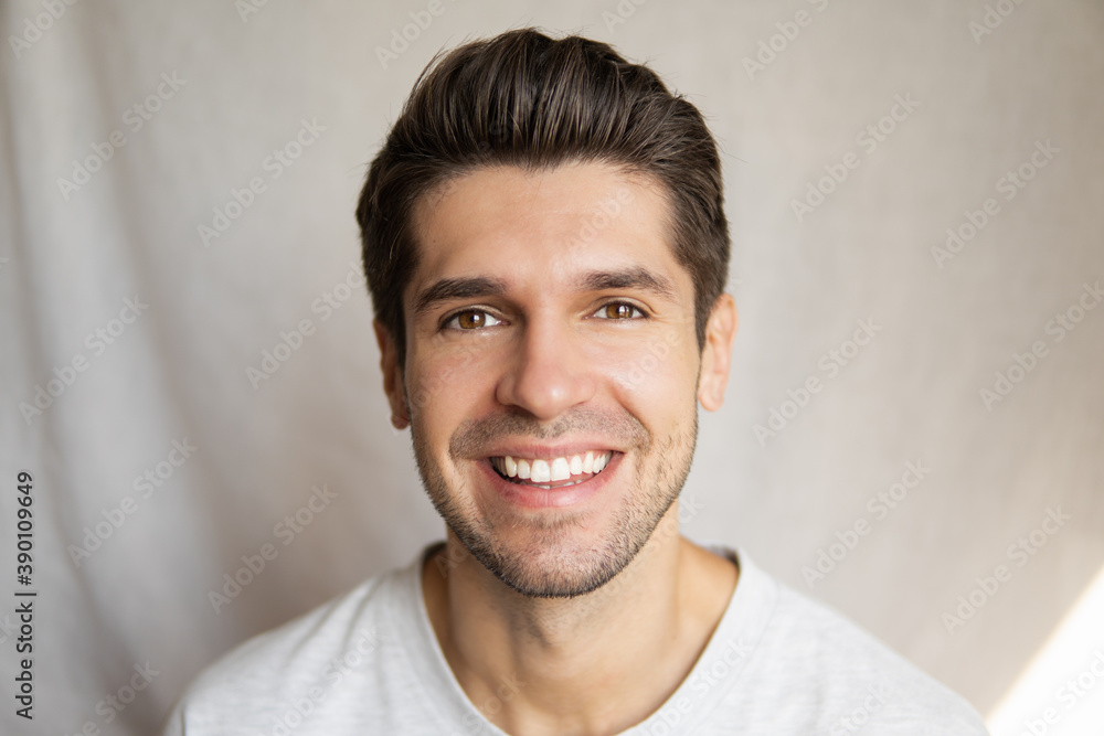 Portrait of a young handsome guy with a beautiful smile with healthy hair, skin and teeth Portrait of a young handsome guy with a beautiful smile with healthy hair, skin and teeth