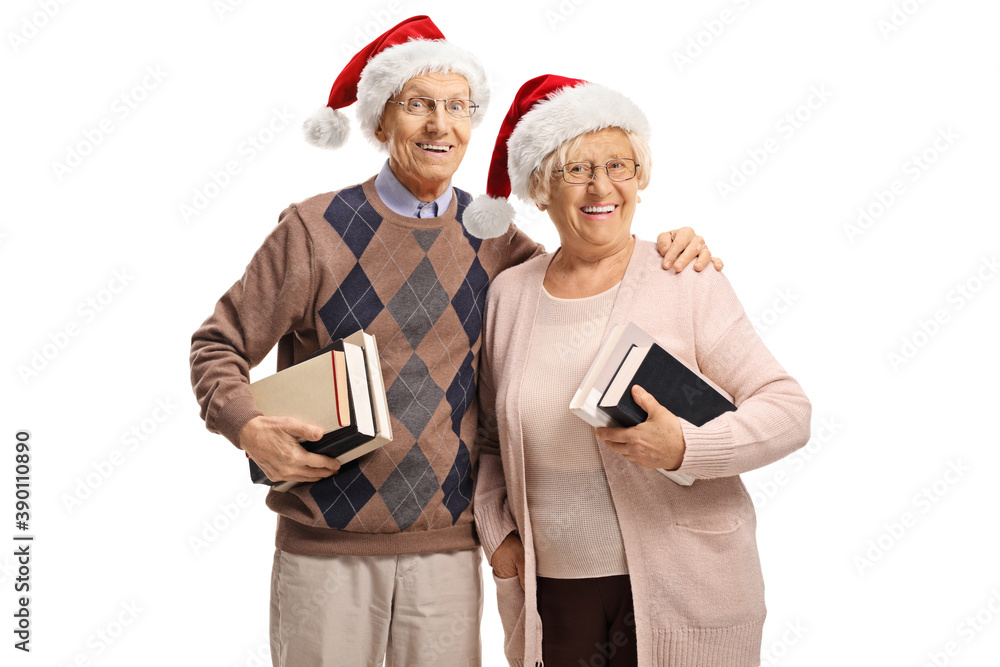 Elderly couple wearing Santa Claus hats and holding books Elderly couple wearing Santa Claus hats and holding books