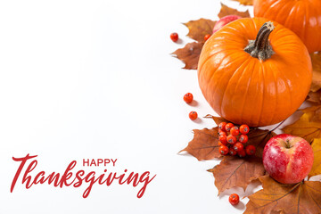 Thanksgiving greetings. Dry yellow leaves, pumpkins, berries and apples on a white background, top view. Kaligraphic capital inscription.