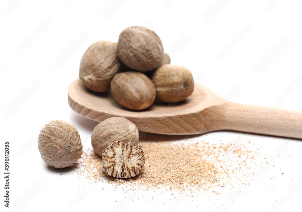 Nutmeg seeds and milled powder with wooden spoon isolated on white background Nutmeg seeds and milled powder with wooden spoon isolated on white background