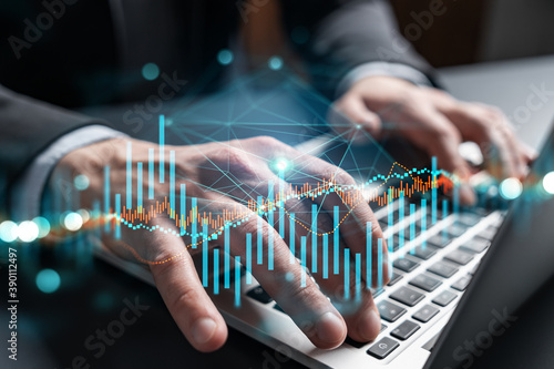 Businessman trading on-line, typing laptop background and forex graph hologram.