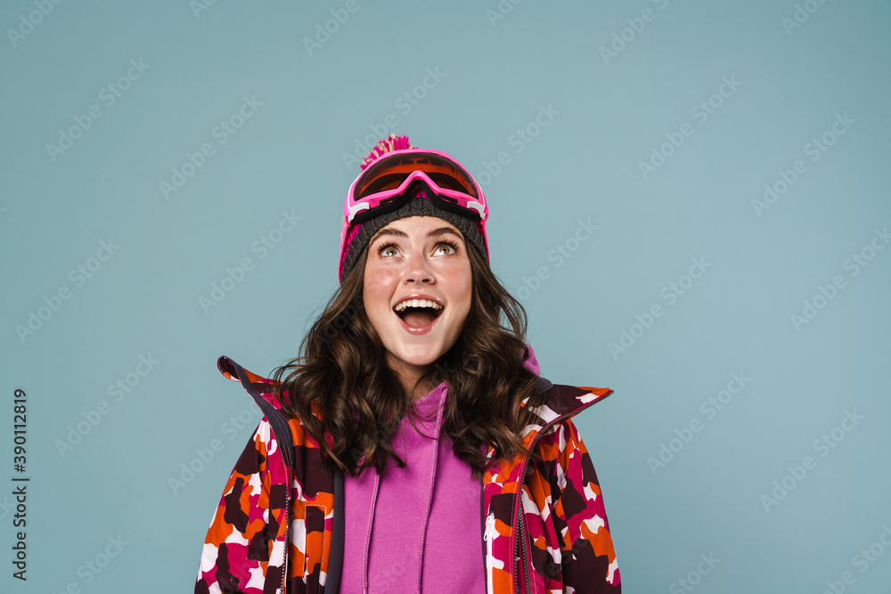 Happy young woman wearing snowboarding gear Happy young woman wearing snowboarding gear