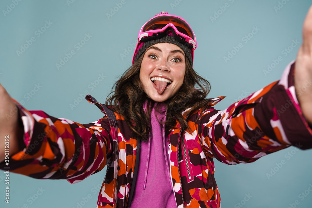 Cheerful young woman wearing snowboard gear Cheerful young woman wearing snowboard gear