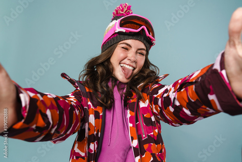 Cheerful young woman wearing snowboard gear