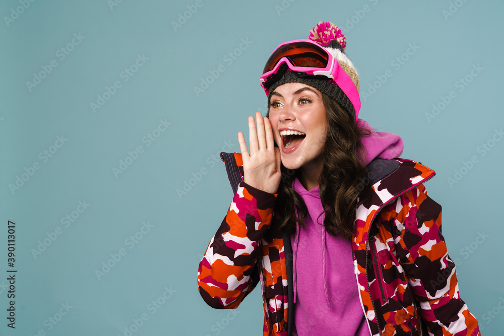Happy young woman wearing snowboarding gear
