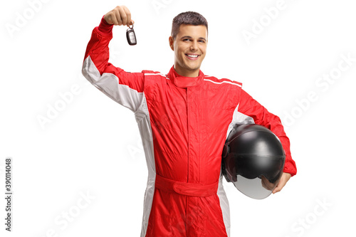 Male racer standing and holding a helmet and a car key