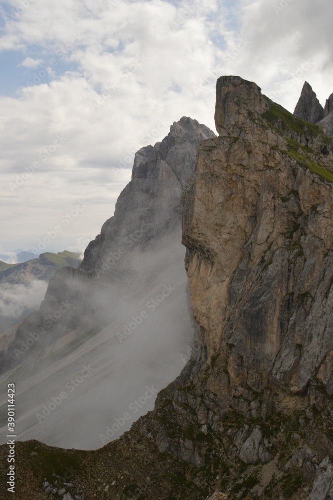 Hiking on the dramatic mountain ridge of Seceda in South Tyrol's Dolomites, Northern Italy Hiking on the dramatic mountain ridge of Seceda in South Tyrol's Dolomites, Northern Italy