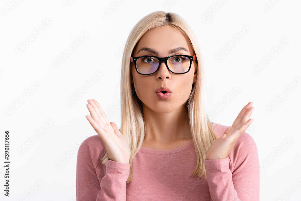 Shocked blonde woman in eyeglasses looking away isolated on white