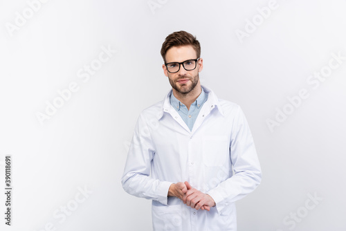 Ophthalmologist in white coat standing isolated on grey © LIGHTFIELD STUDIOS