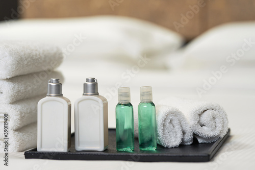 Bed with fresh towels and amenities in hotel