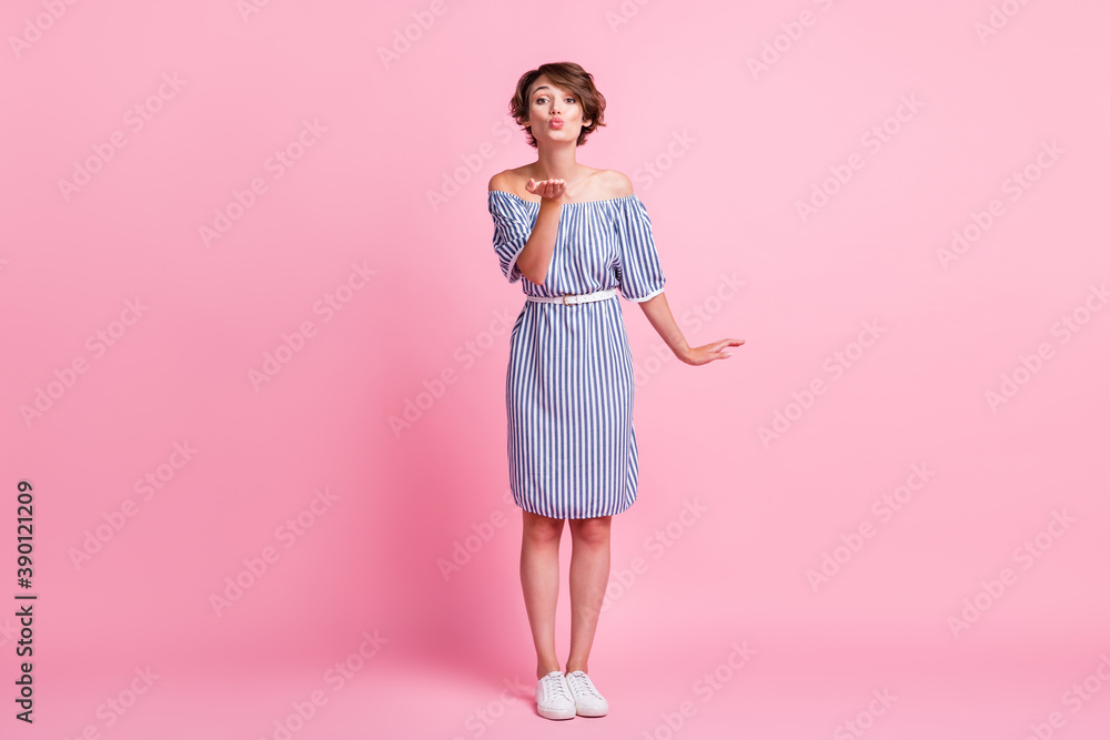 Photo portrait of adorable girl sending air kiss isolated on pastel pink colored background Photo portrait of adorable girl sending air kiss isolated on pastel pink colored background
