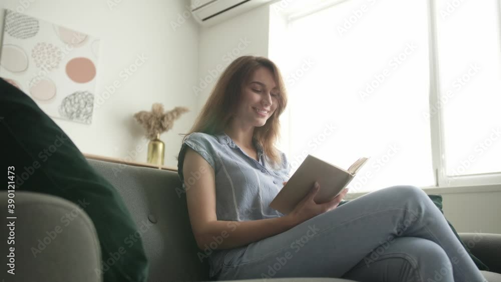 Beautiful young woman reading book at home Beautiful young woman reading book at home