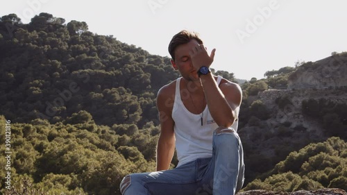 Handsome Guy In Vest Sitting In Spanish Landscape