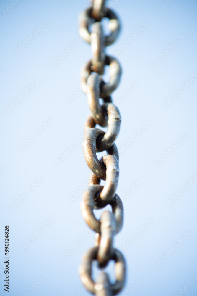 Strong metal chain against the blue sky