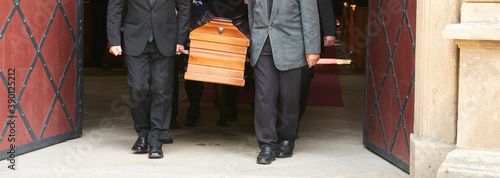 Group of survivors carries a coffin out of the church after a funeral mass