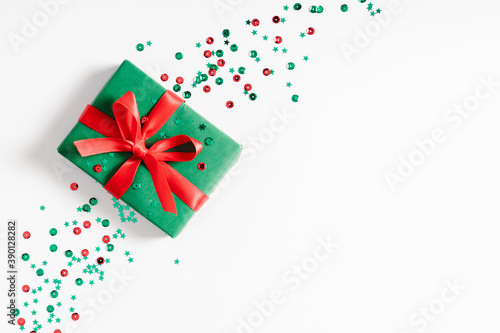 Christmas minimal composition. Xmas red and green decorations  gift on white background. Christmas  New Year  winter concept. Flat lay  top view  copy space