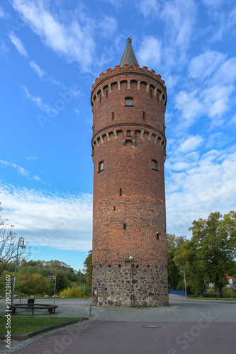 Round medieval fortified tower of brick in Friedland (Mecklenburg-Vorpommern) called Fangelturm, formerly part of the city wall, also used as a prison, later as a water tower, today as lookout point. photo