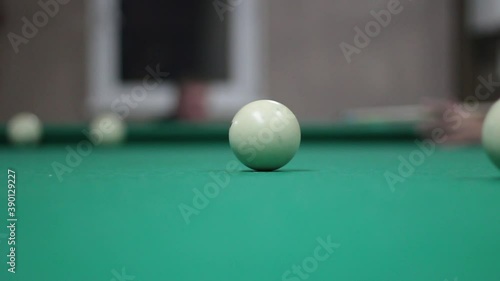 Wallpaper Mural Game of billiards. White billiard balls roll on the table. Sports entertainment in the bar. Simple background with a pool table. Balls hitting and moving. Torontodigital.ca