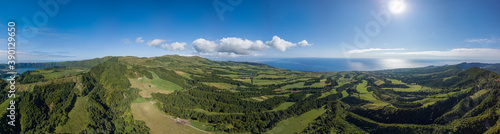 Panoramic view over the green landscape and the Atlantic ocean, in the zona of Sete Cidades, São Miguel island in the Azores.