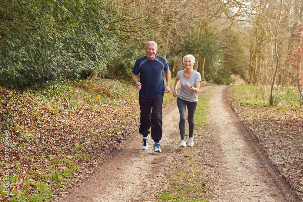 Fototapeta premium Senior Couple Exercising In Autumn Countryside During Covid 19 Lockdown