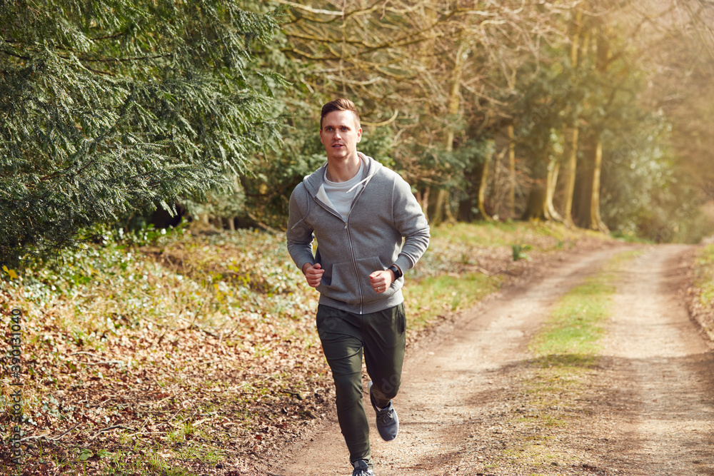 Smiling Man Running In Autumn Countryside Exercising During Covid 19 Lockdown Smiling Man Running In Autumn Countryside Exercising During Covid 19 Lockdown