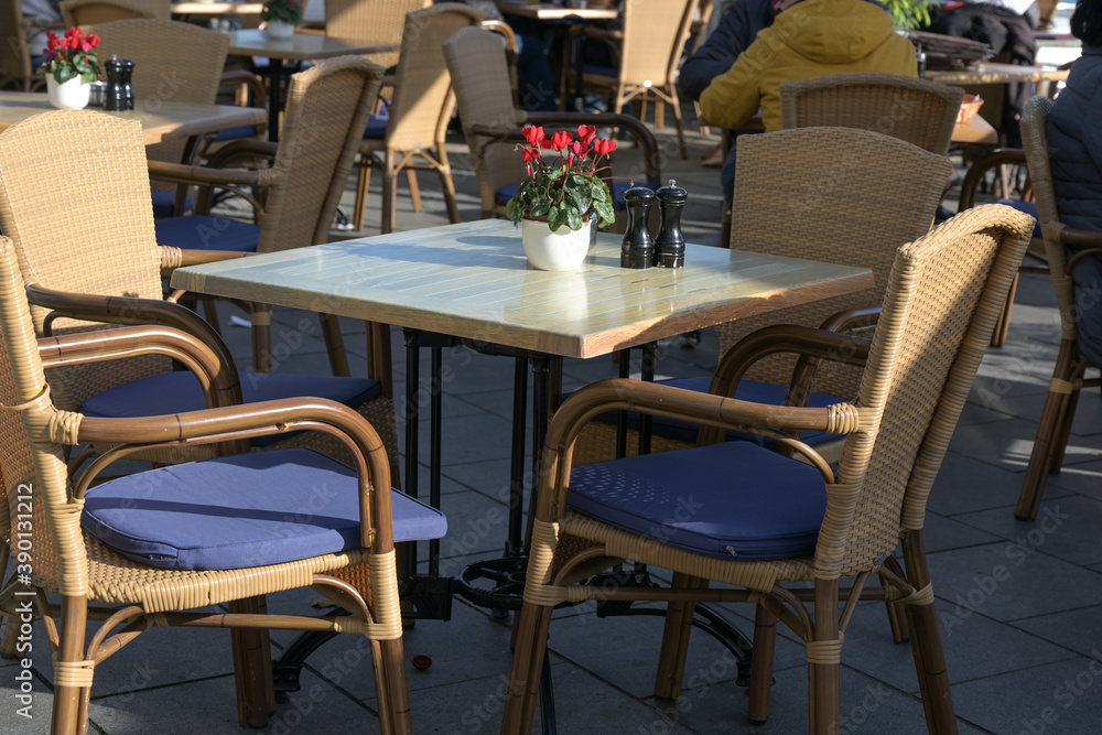 Empty table in a street cafe at a sunny day after the strict lockdown during the coronavirus pandemic