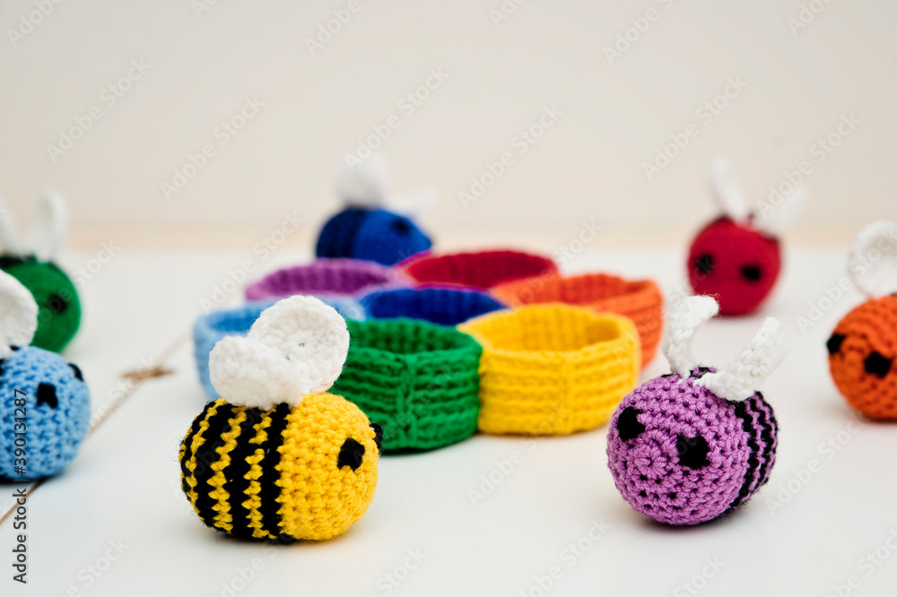 Colorful beehive with bees. Crochet safe toys for babies. Processed egg craft ideas are a bright Easter-colored rainbow-colored educational toy. Preschool game for young children. Montessori education