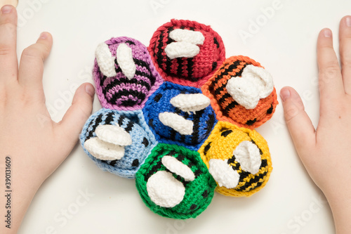 Colorful beehive with bees. Crochet safe toys for babies. Processed egg craft ideas are a bright Easter-colored rainbow-colored educational toy. Preschool game for young children. Montessori education