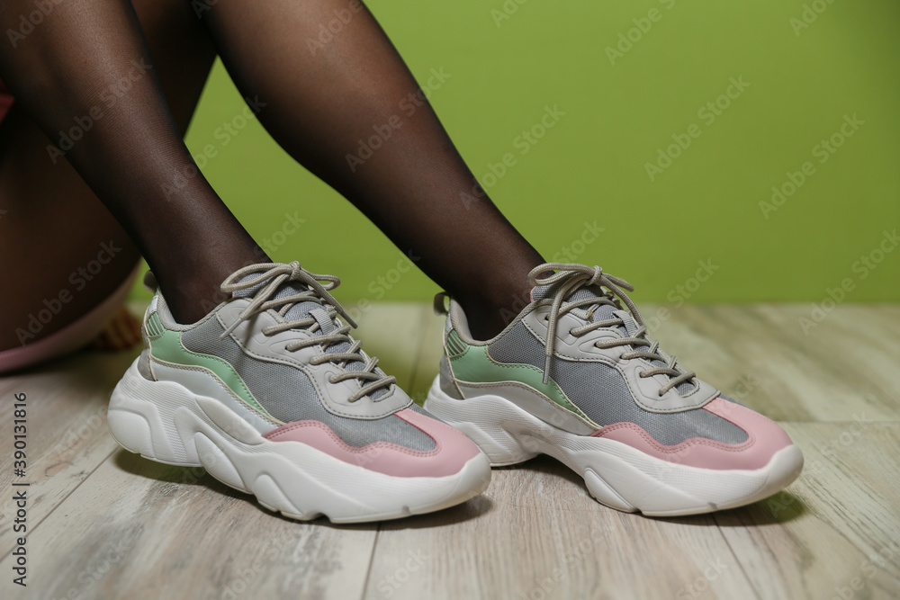 female legs wearing sports sneakers close-up
