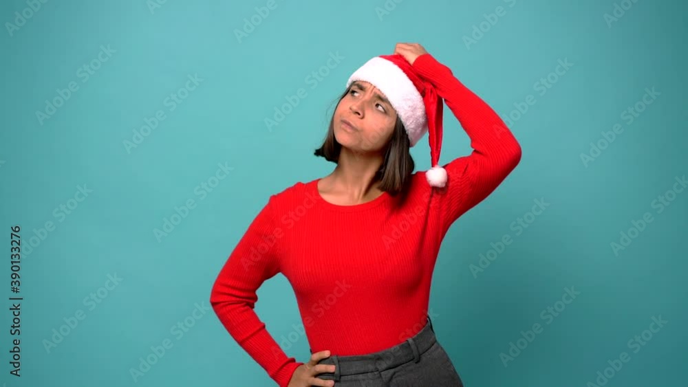 woman having doubts while scratching head in christmas holidays woman having doubts while scratching head in christmas holidays
