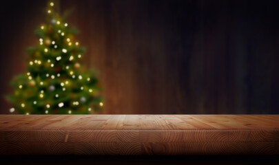 A Christmas wood tabletop product display with a festive background of a Christmas Tree and lights with an empty space on the table.
