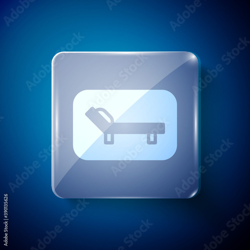 White Sunbed icon isolated on blue background. Sun lounger. Square glass panels. Vector.