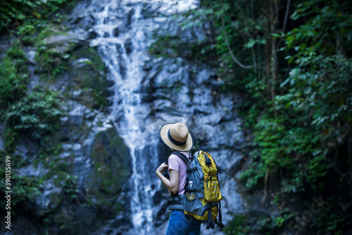 women in nature, backpackers,Women with backpackers enjoy waterfalls, nature tourism concept.