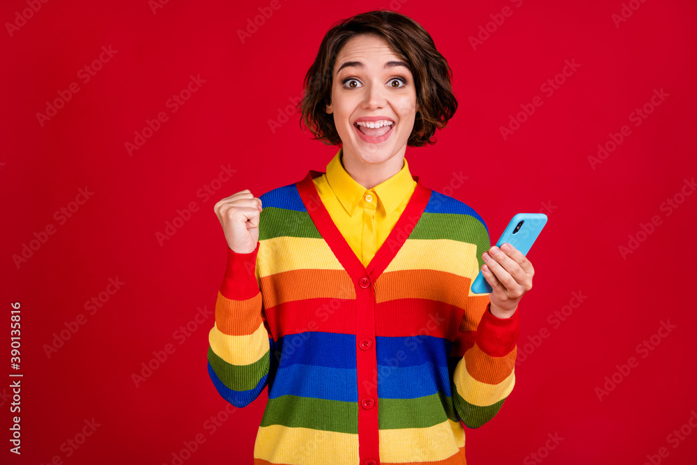 Photo of beautiful excited lady blogger hold telephone raise fist open mouth many new followers lgbt gay lesbian community wear stripes jumper cardigan isolated red color background Photo of beautiful excited lady blogger hold telephone raise fist open mouth many new followers lgbt gay lesbian community wear stripes jumper cardigan isolated red color background