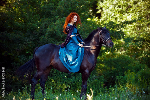 cosplay Braveheart red curly girl with a horse in the woods