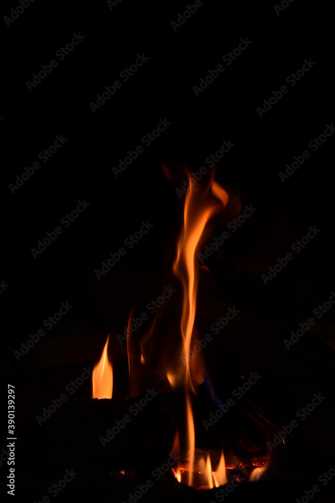 Warm fire and sparks in a fire-place from conflagrant wooden logs