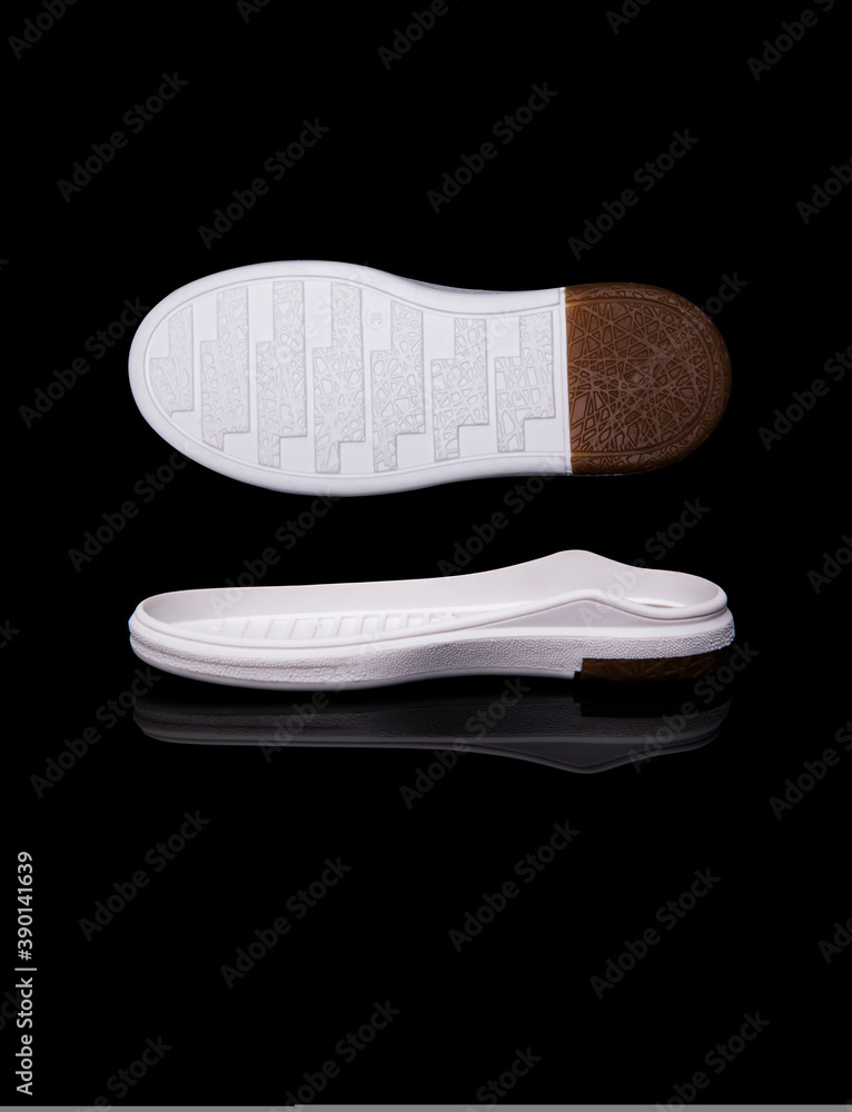 white shoe sole. Isolated on a black background. white shoe sole. Isolated on a black background.