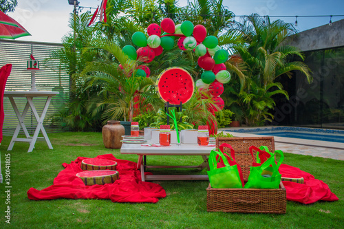 Picnic tables decorated with watermelon-themed decorations photo