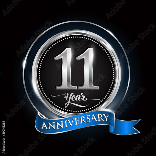 Celebrating 11th years anniversary logo. with silver ring and blue ribbon.