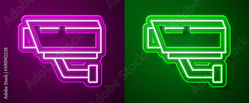 Glowing neon line Security camera icon isolated on purple and green background. Vector.