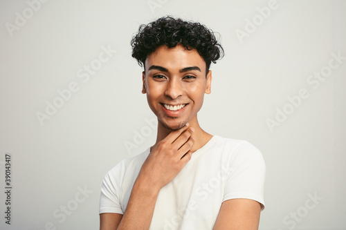 Handsome gay man on white background photo