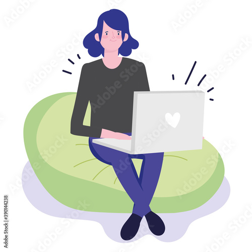young woman sitting on bean chair with laptop working
